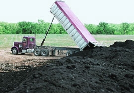 Truck dumping river sludge